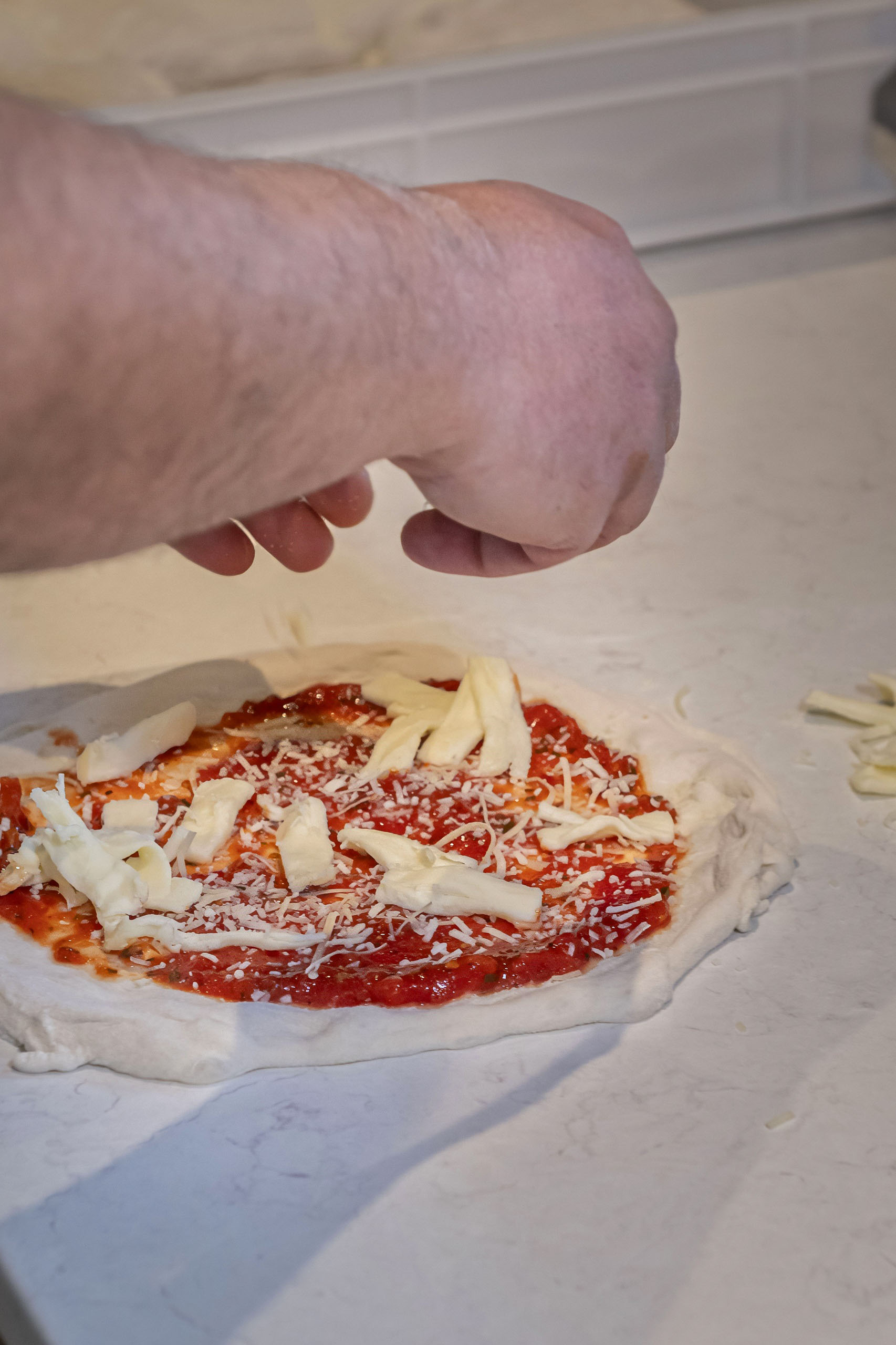 Topping a Neapolitan pizza